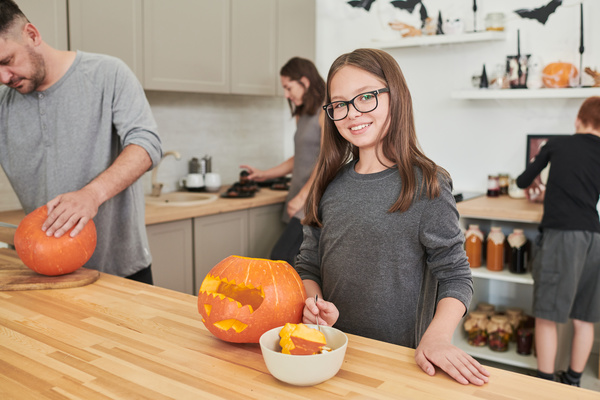 Girl and Her Family Are Busy Preparing Decorations for Halloween